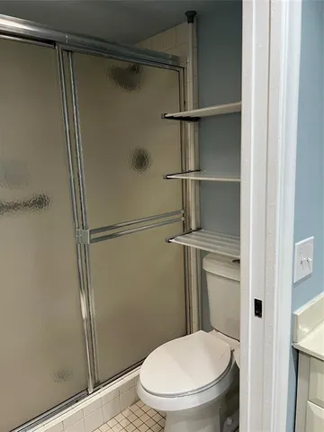 a bathroom with a glass shower door
