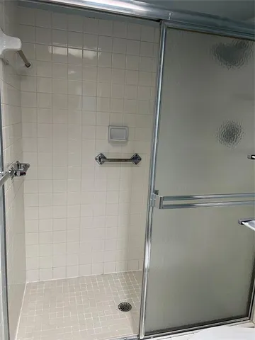 a white toilet sitting next to a shower
