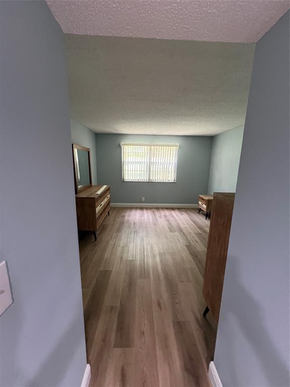 1605 Abaco Drive, Unit 1605 J1 Coconut Creek, FL 33066 - Photo 30 of 71 a view of wooden floor and windows in a room