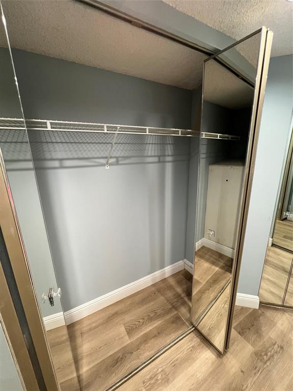 1605 Abaco Drive, Unit 1605 J1 Coconut Creek, FL 33066 - Photo 31 of 71 a view of walk in closet with wooden floor