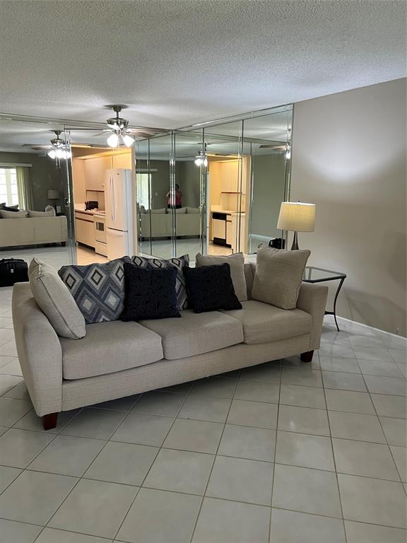 1605 Abaco Drive, Unit 1605 J1 Coconut Creek, FL 33066 - Photo 35 of 71 a living room with furniture and a large window