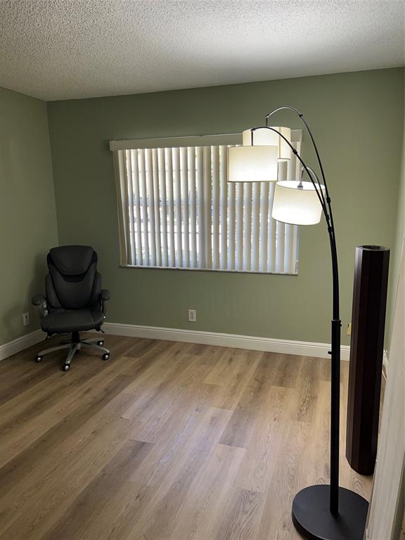 1605 Abaco Drive, Unit 1605 J1 Coconut Creek, FL 33066 - Photo 37 of 71 a room with gym equipment and a large window