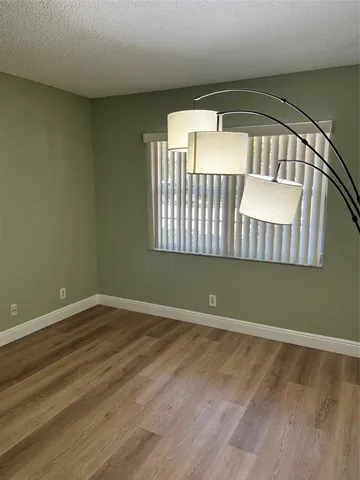 a living room with a couch and a view of kitchen