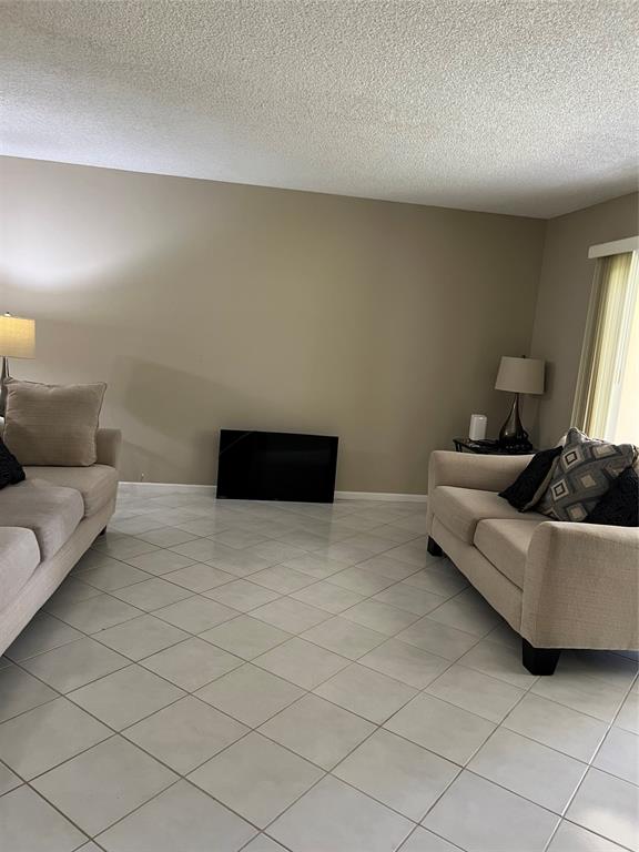 1605 Abaco Drive, Unit 1605 J1 Coconut Creek, FL 33066 - Photo 49 of 71 a living room with furniture and a couch