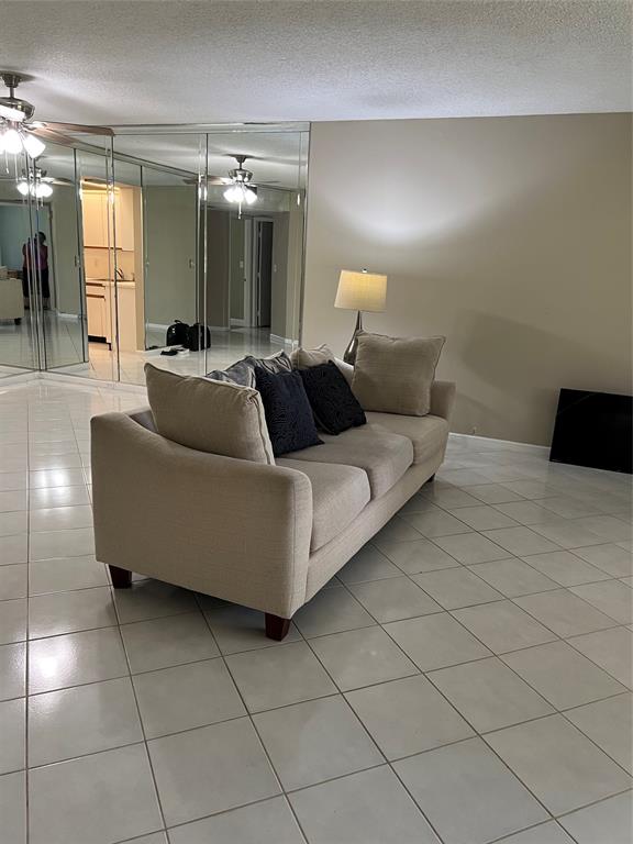 1605 Abaco Drive, Unit 1605 J1 Coconut Creek, FL 33066 - Photo 50 of 71 a living room with a couch and a view of kitchen