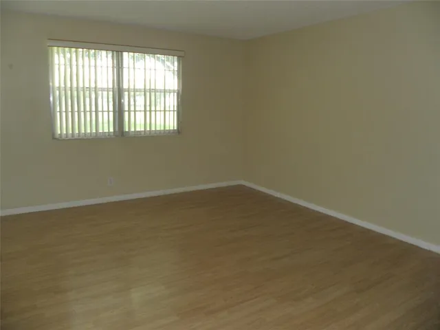 a view of a closet area with furniture and wooden floor
