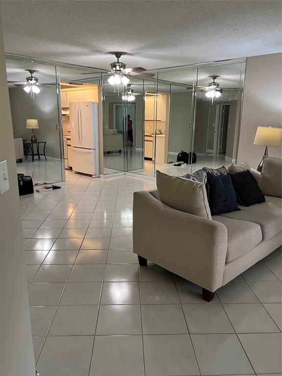 1605 Abaco Drive, Unit 1605 J1 Coconut Creek, FL 33066 - Photo 51 of 71 a living room with furniture and a large mirror
