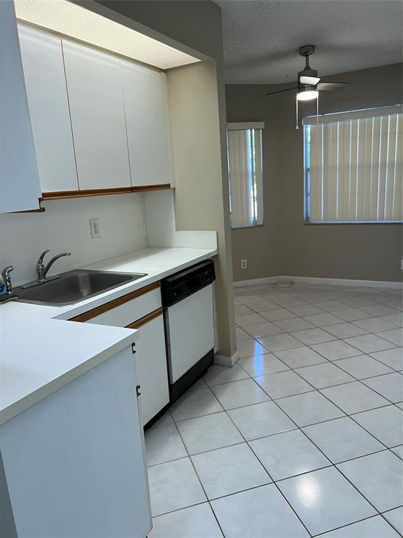 1605 Abaco Drive, Unit 1605 J1 Coconut Creek, FL 33066 - Photo 58 of 71 a kitchen with a sink and cabinets
