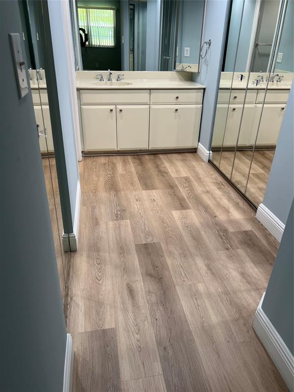 1605 Abaco Drive, Unit 1605 J1 Coconut Creek, FL 33066 - Photo 6 of 71 a view of a closet area with furniture and wooden floor