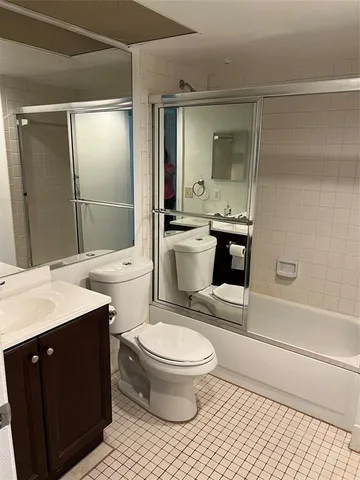 a view of a fountain with palm trees