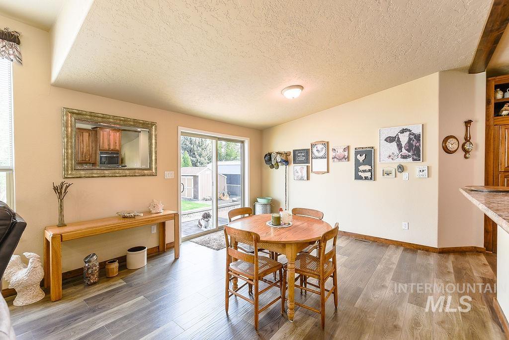 414 South Garfield Street Genesee, ID 83832 - Photo 15 of 50 Dining space featuring vaulted ceiling, a textured ceiling, and light wood finished floors