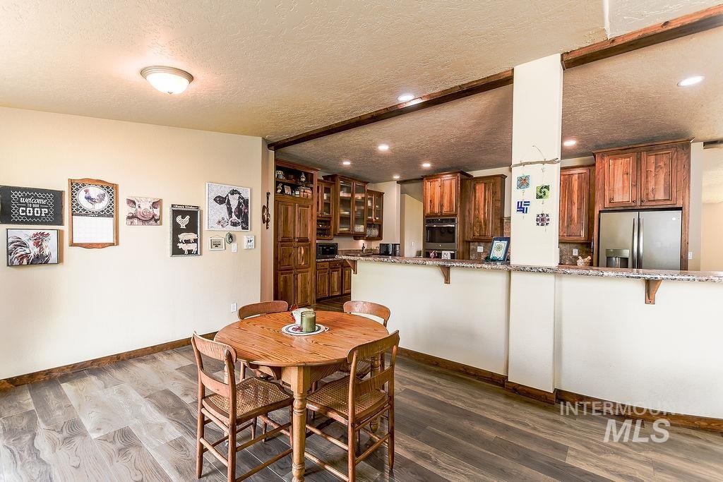 414 South Garfield Street Genesee, ID 83832 - Photo 16 of 50 Dining space with a textured ceiling and dark wood-style flooring