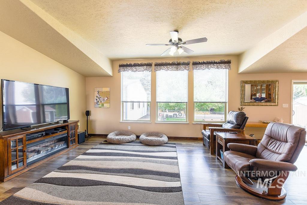 414 South Garfield Street Genesee, ID 83832 - Photo 18 of 50 Living room featuring a textured ceiling, wood finished floors, and ceiling fan