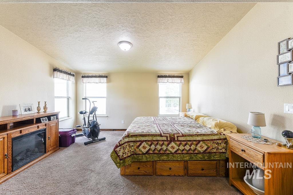 414 South Garfield Street Genesee, ID 83832 - Photo 22 of 50 Carpeted bedroom featuring a textured ceiling and a textured wall