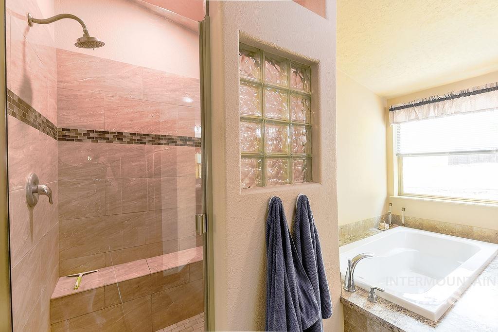 414 South Garfield Street Genesee, ID 83832 - Photo 25 of 50 Bathroom with a shower stall, a garden tub, and a textured ceiling