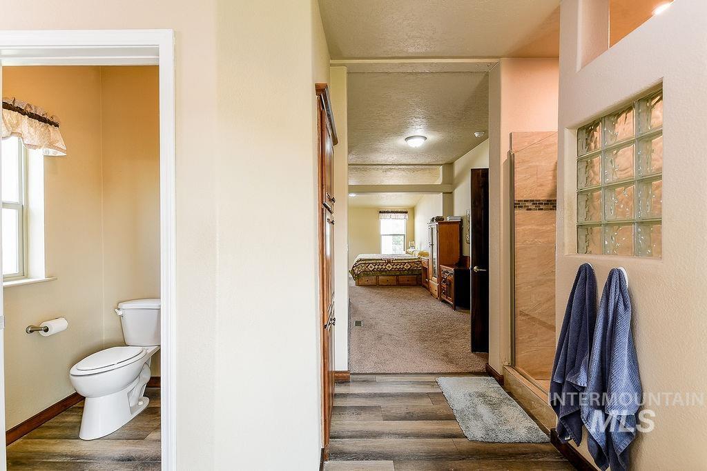 414 South Garfield Street Genesee, ID 83832 - Photo 28 of 50 Bathroom featuring a textured ceiling and dark wood-style floors