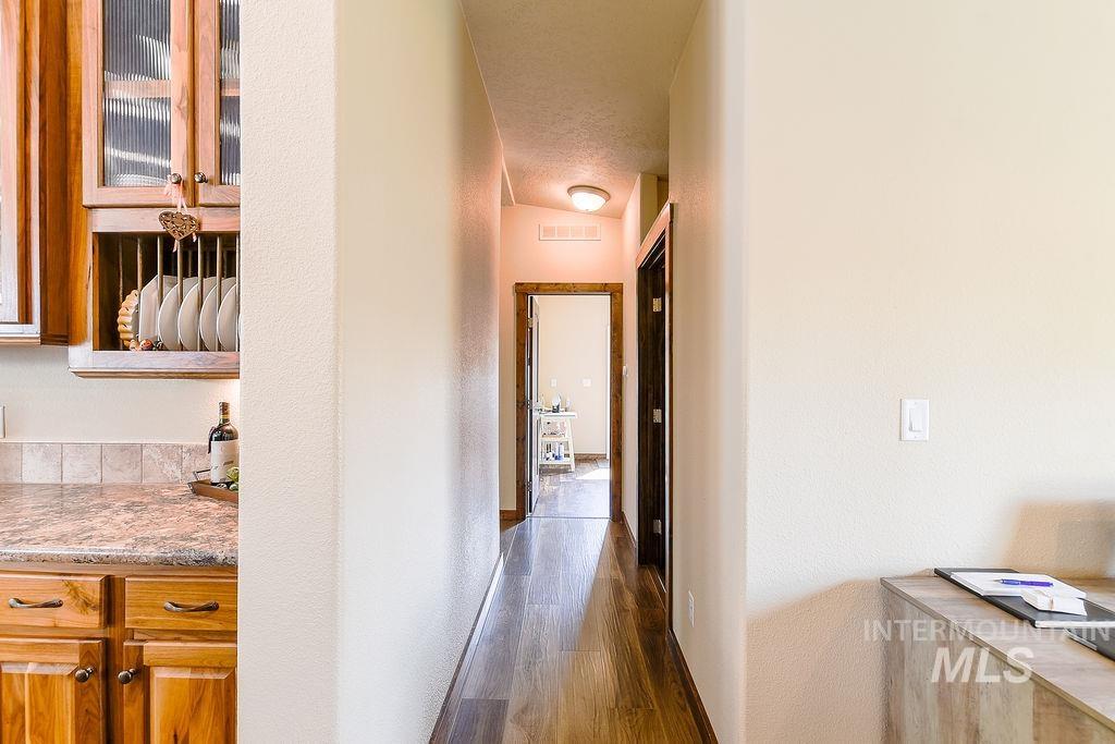 414 South Garfield Street Genesee, ID 83832 - Photo 30 of 50 Hall featuring a textured wall and dark wood-style flooring
