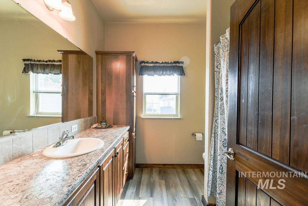 414 South Garfield Street Genesee, ID 83832 - Photo 34 of 50 Full bath with vanity and dark wood-style floors