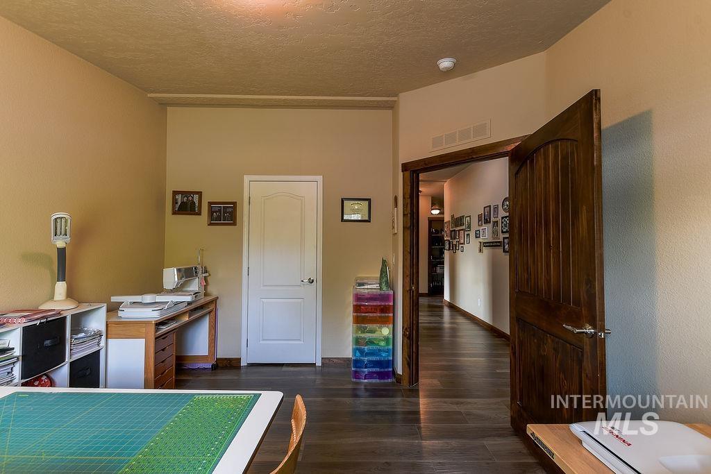 414 South Garfield Street Genesee, ID 83832 - Photo 38 of 50 Bedroom featuring dark wood-type flooring and a textured ceiling