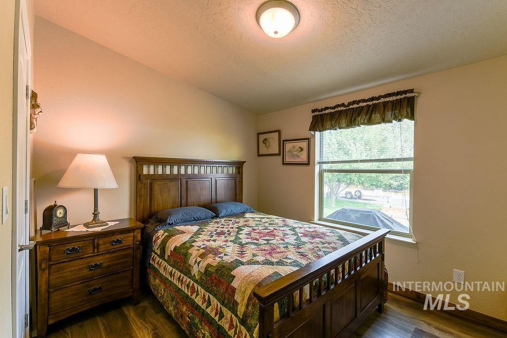 414 South Garfield Street Genesee, ID 83832 - Photo 39 of 50 Bedroom with dark wood-type flooring, vaulted ceiling, and a textured ceiling