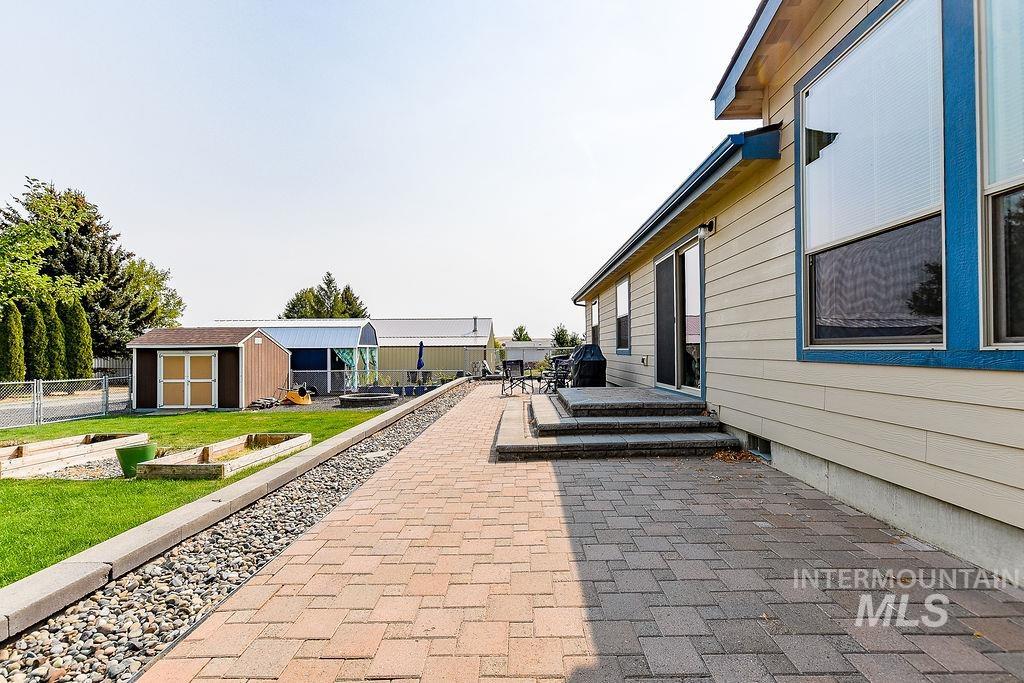 414 South Garfield Street Genesee, ID 83832 - Photo 41 of 50 View of patio featuring a shed and a vegetable garden
