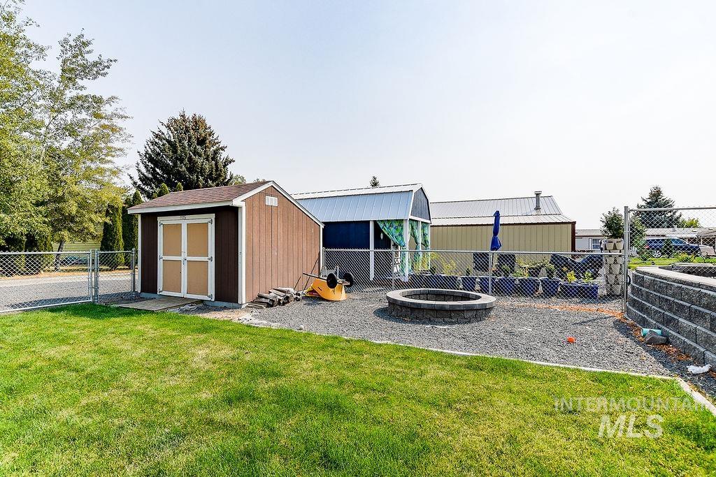 414 South Garfield Street Genesee, ID 83832 - Photo 42 of 50 Fenced backyard with a shed, a fire pit, and a gate