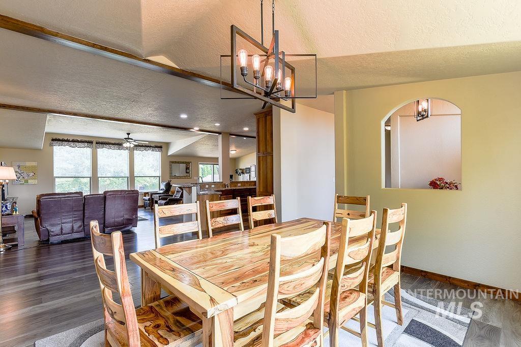 414 South Garfield Street Genesee, ID 83832 - Photo 6 of 50 Dining space with a textured ceiling, wood finished floors, a ceiling fan, a chandelier, and recessed lighting