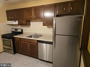 a kitchen with a refrigerator and cabinets