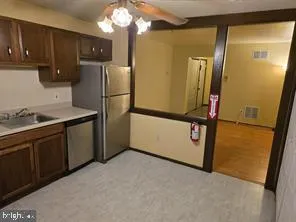 a kitchen with stainless steel appliances granite countertop a refrigerator a sink and dishwasher