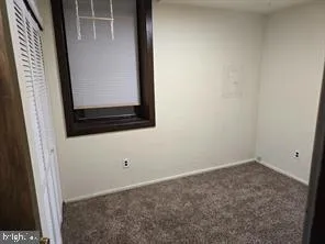 an empty room with closet area