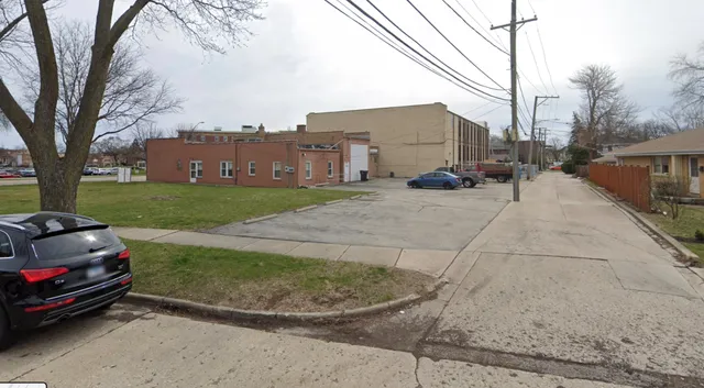 a view of a car park in front of a house
