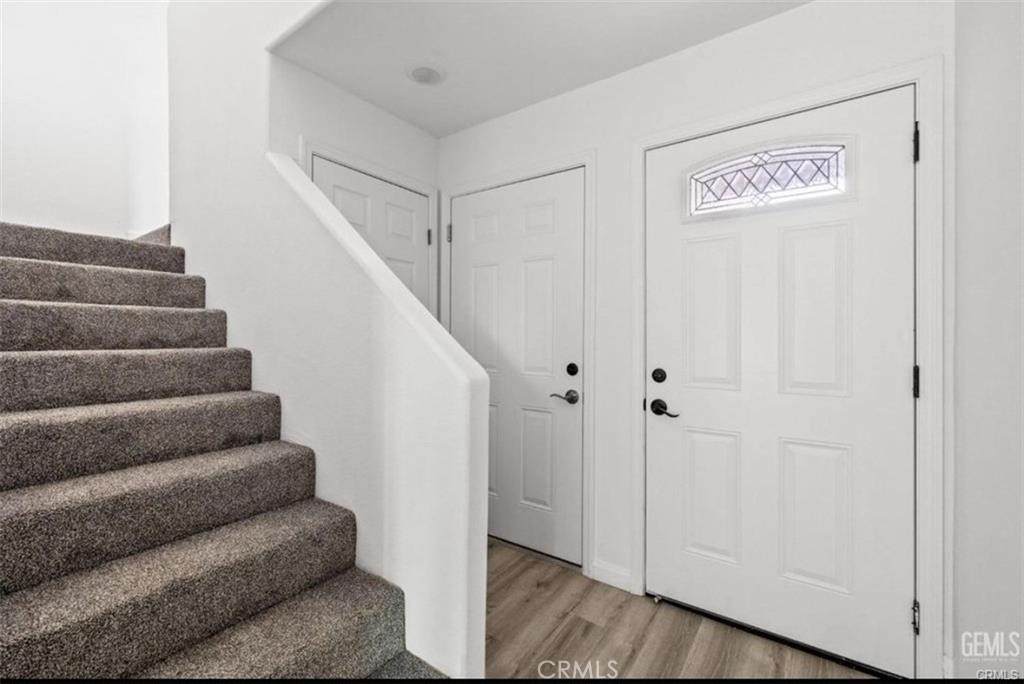 1413 Oregon Street Bakersfield, CA 93305 - Photo 3 of 8 a view of entryway with stairs and wooden floor