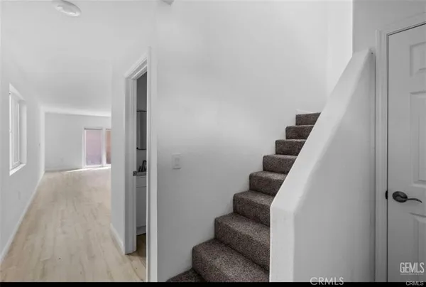 a view of entryway and hall with wooden floor