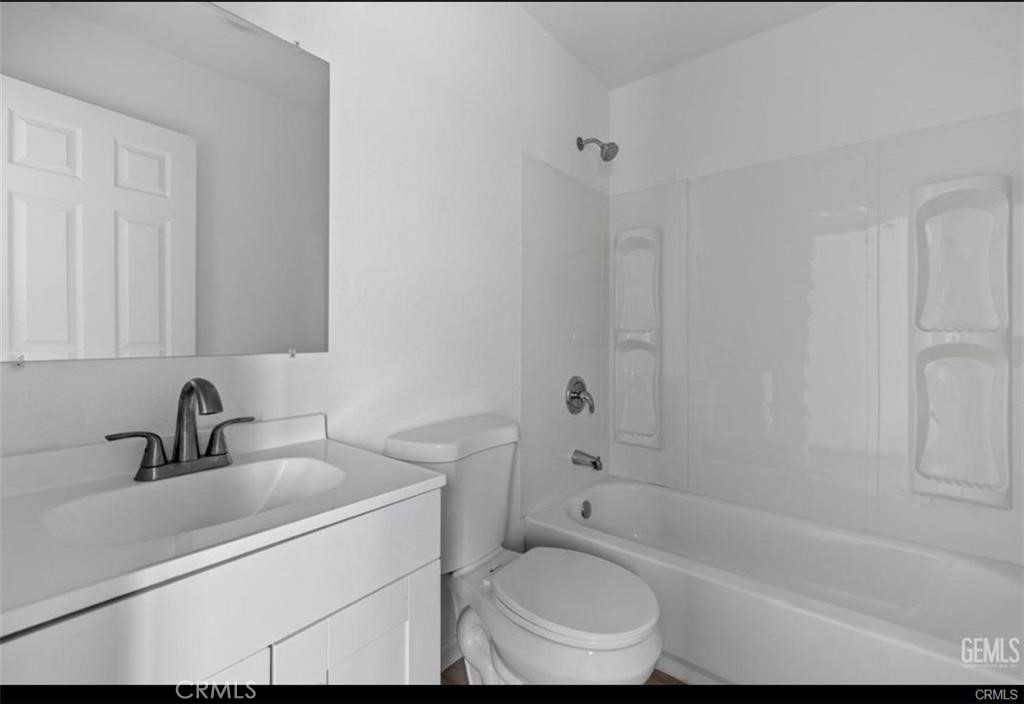 1413 Oregon Street Bakersfield, CA 93305 - Photo 6 of 8 a bathroom with a sink toilet a bathtub and shower