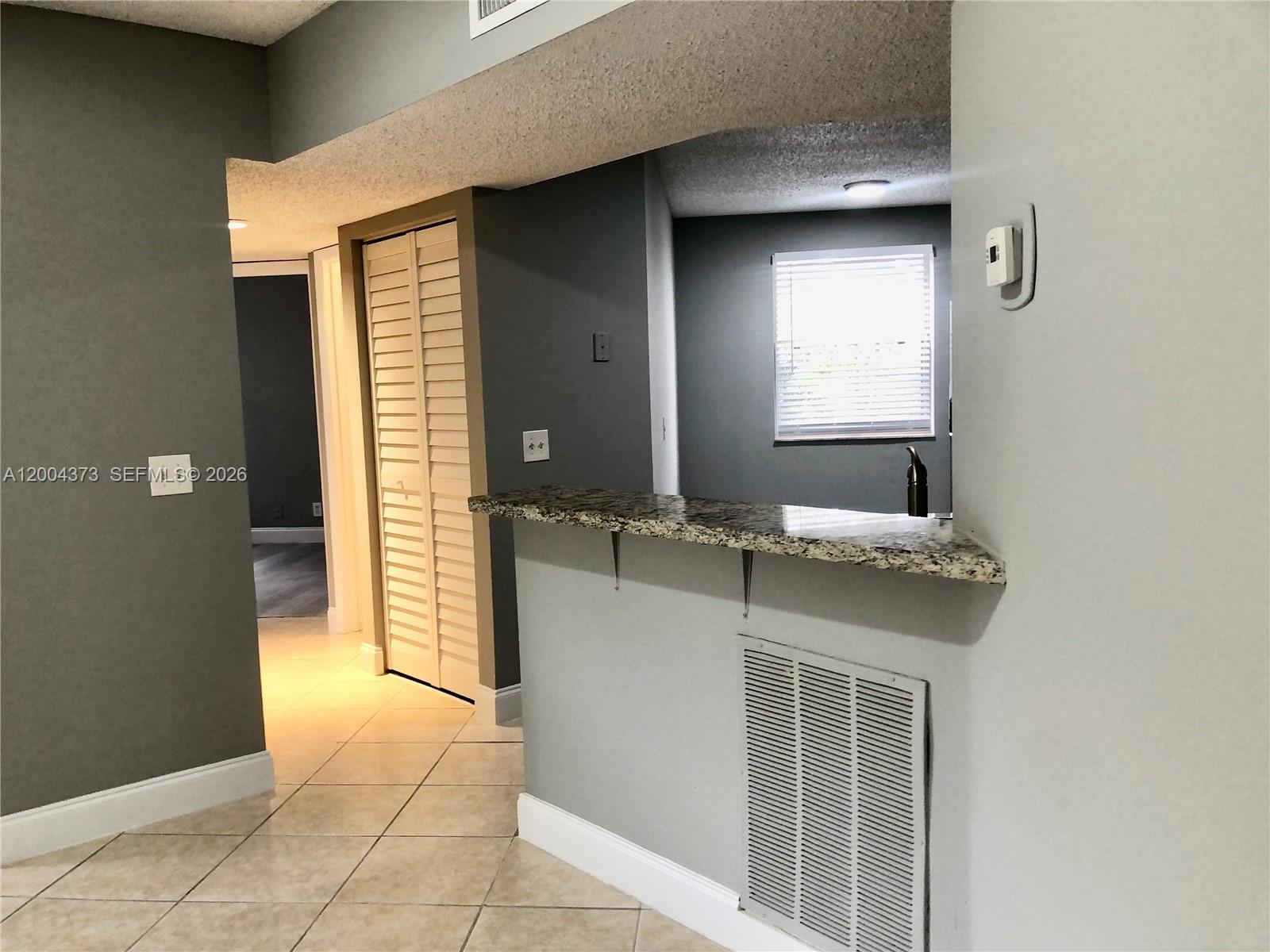 8761 Wiles Road, Unit 306 Coral Springs, FL 33067 - Photo 8 of 26 a bathroom with a granite countertop sink and a mirror