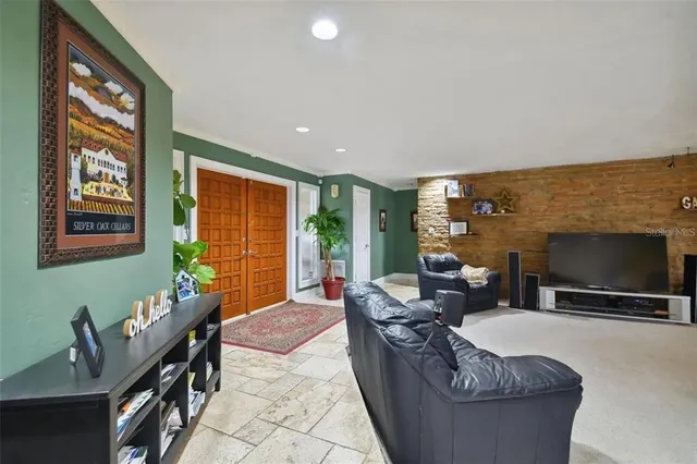 a living room with fireplace furniture and a flat screen tv