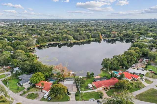 an aerial view of lake residential house with swimming pool and outdoor space