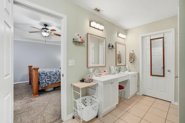 a bathroom with a double vanity sink mirror and