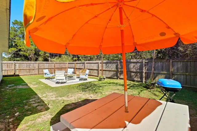 a view of a backyard with sitting area