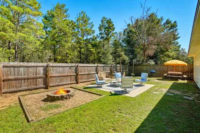 a view of a backyard with swimming pool