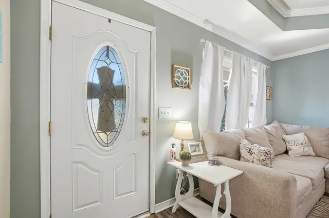 a living room with furniture a mirror and a window