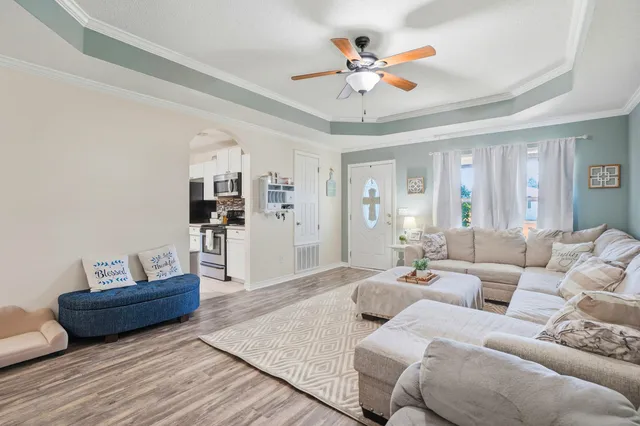 a living room with furniture and wooden floor