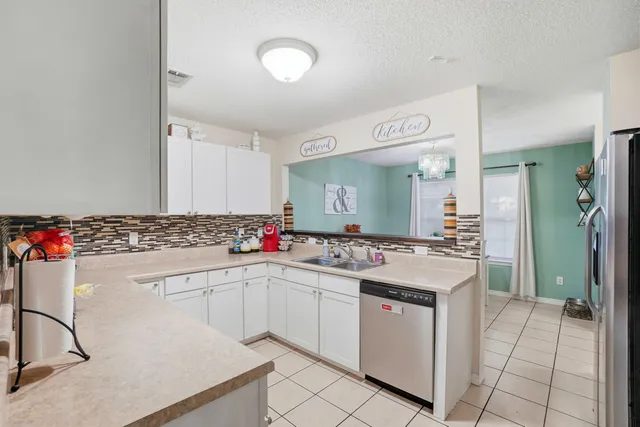 a kitchen with a sink stove and cabinets