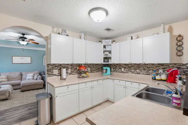 a kitchen with a sink cabinets and wooden floor