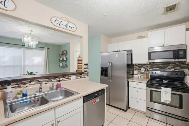 a kitchen with a sink cabinets and stainless steel appliances