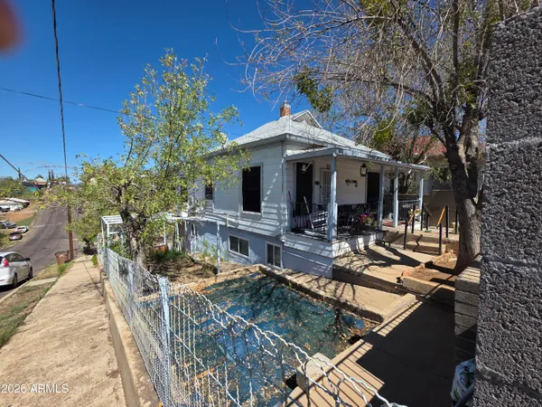 a view of house with swimming pool outdoor seating