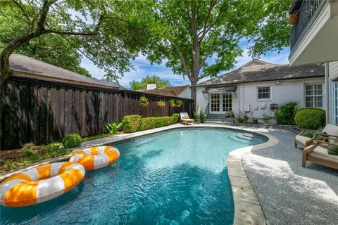 a view of a house with swimming pool and porch