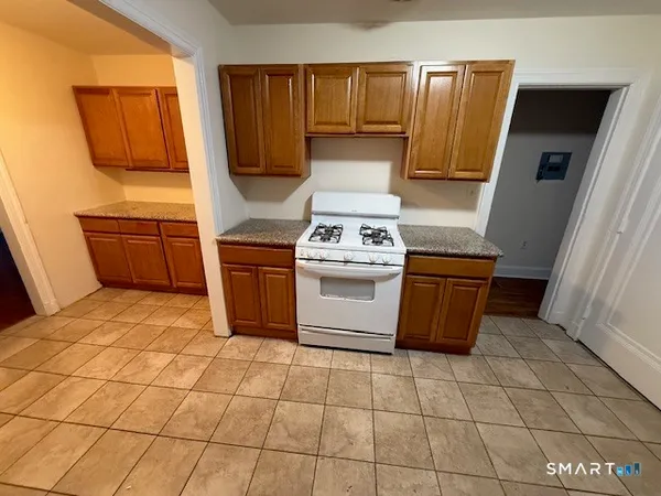 a kitchen with a stove top oven cabinets and appliances