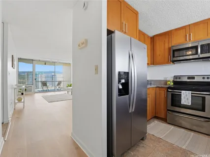 a kitchen with stainless steel appliances granite countertop a refrigerator and a stove top oven