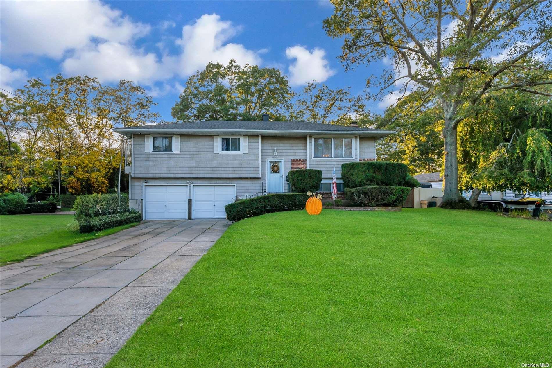 a front view of a house with a garden and outdoor seating